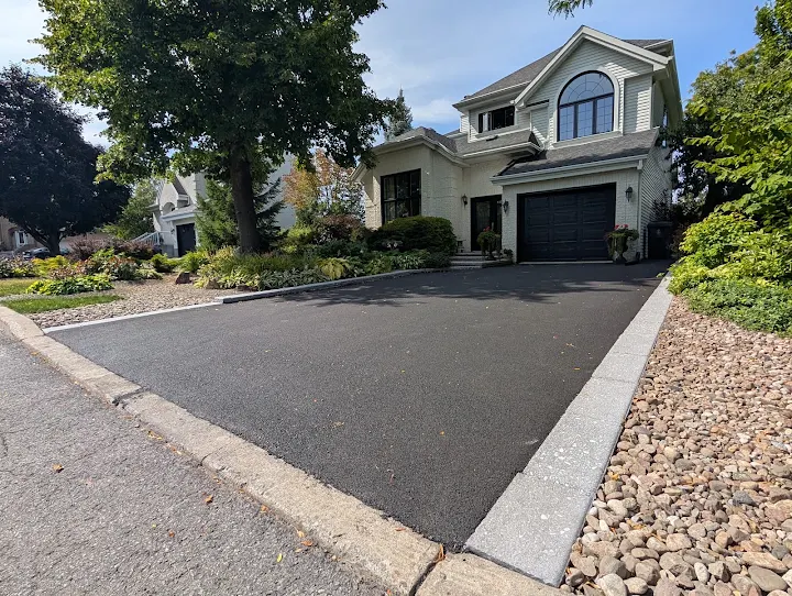 Freshly surfaced asphalt driveway with paved edging