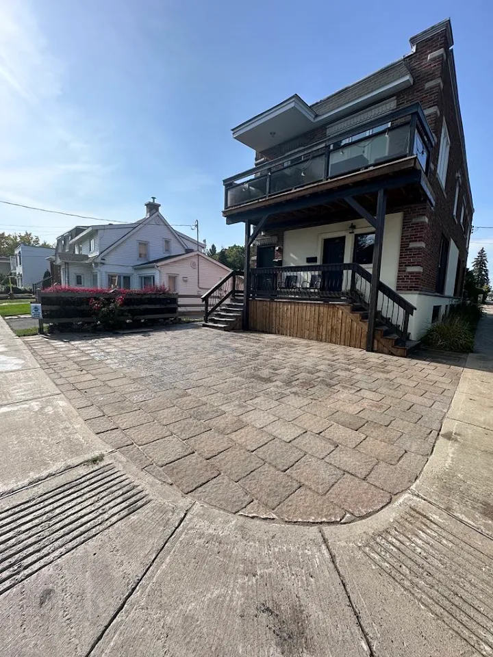 Circular cobble paved forecourt at a double-storey home