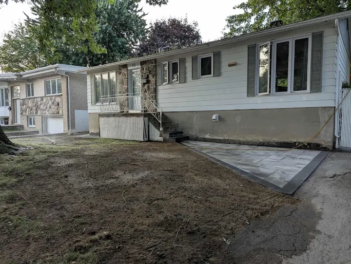 New paved walkway alongside a home after site clearing