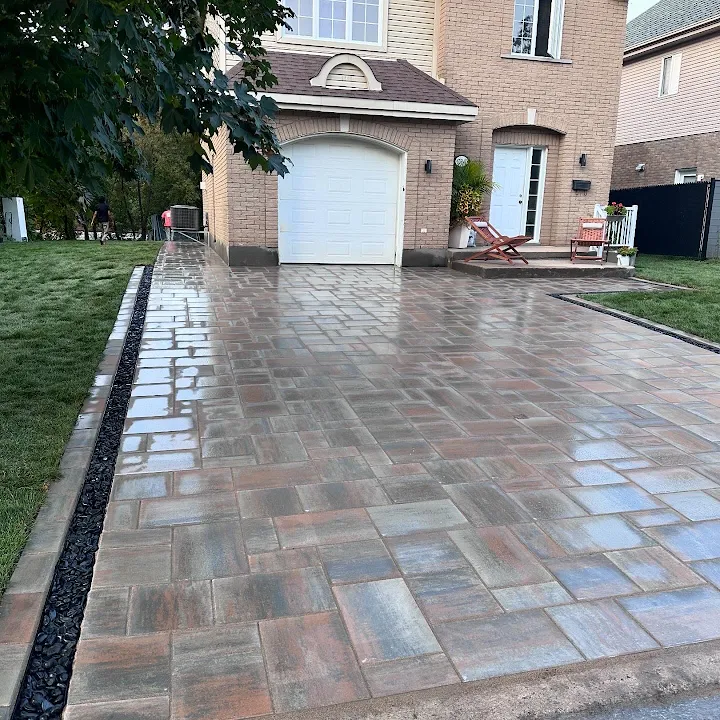 Multi-tone brick paved driveway leading to a double garage