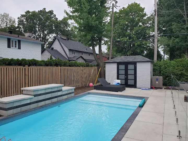 Modern rectangular swimming pool with paved surround